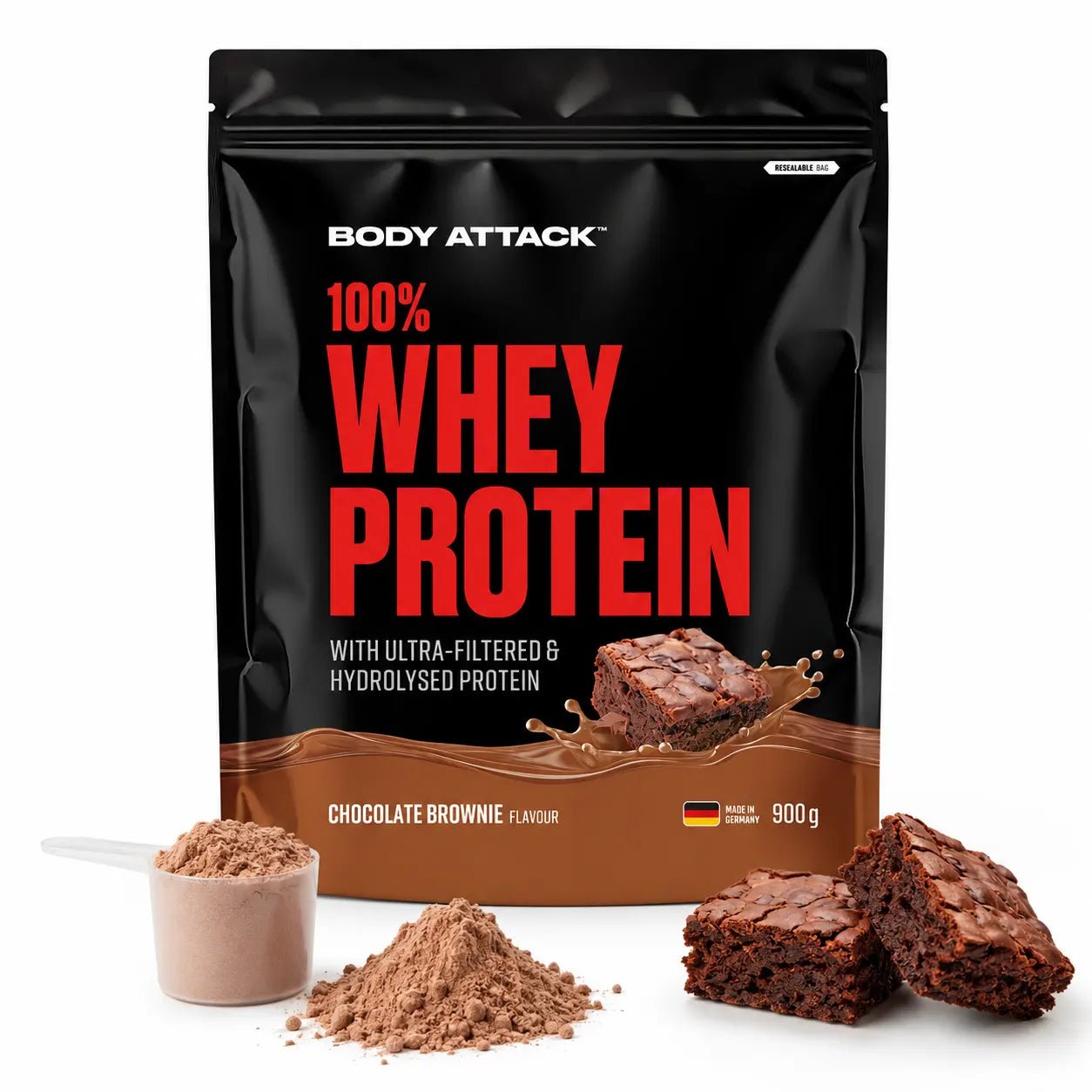 A 900 g bag of Body Attack 100% Whey Protein in Chocolate Flavour, displayed alongside chocolate pieces, a scoop of powder, and a pile of powder on a black background.
