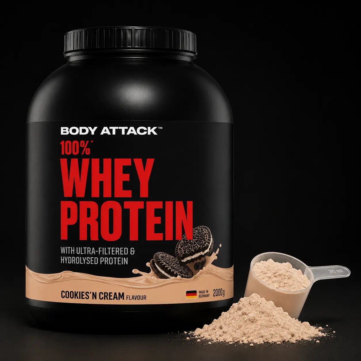Body Attack 100% Whey Protein in Cookies 'N Cream flavor, shown with a scoop and a small pile of light beige powder on a black background.