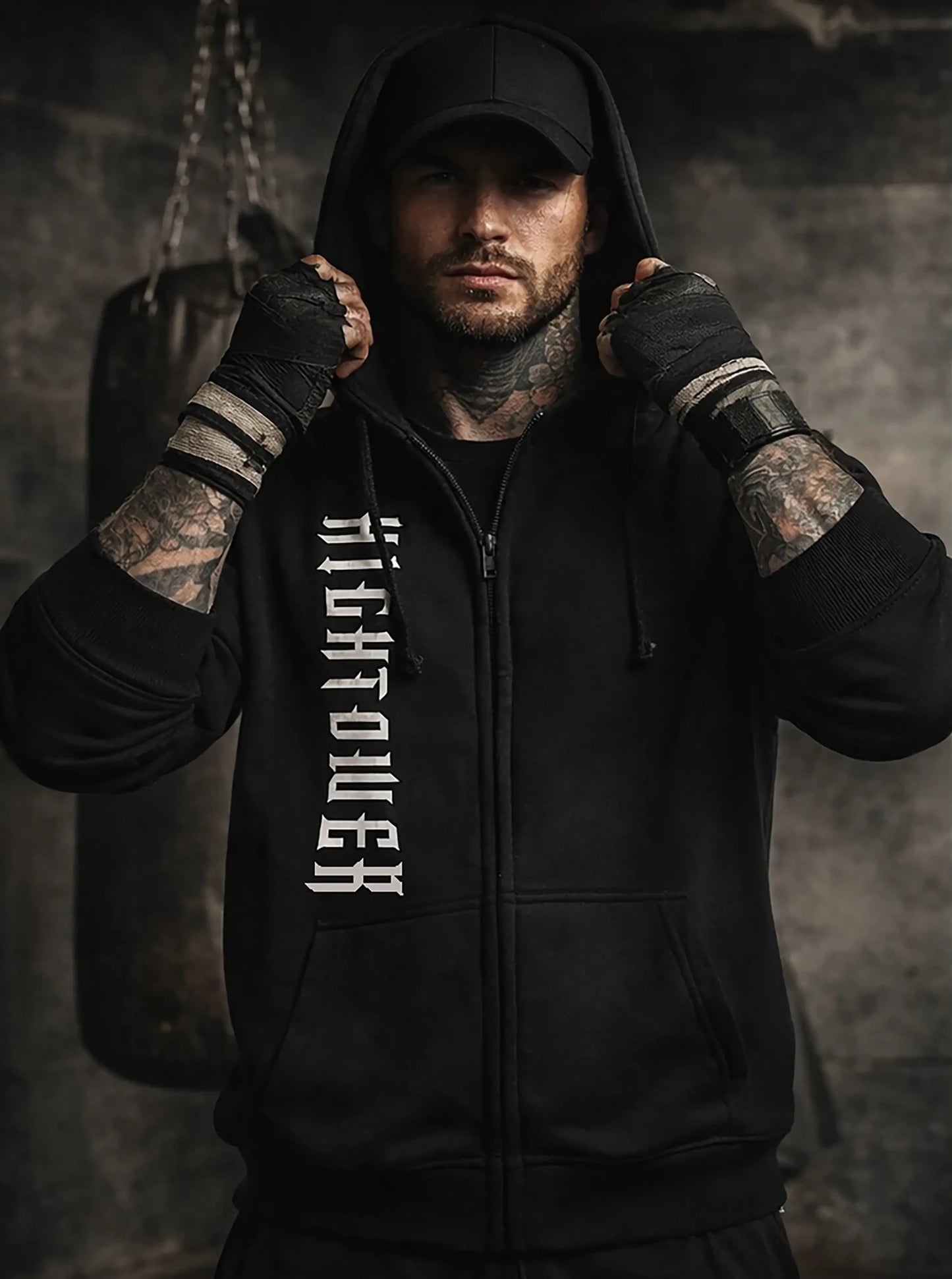 Man wearing a black hoodie with 'Righteous' text, standing against a dark background.
