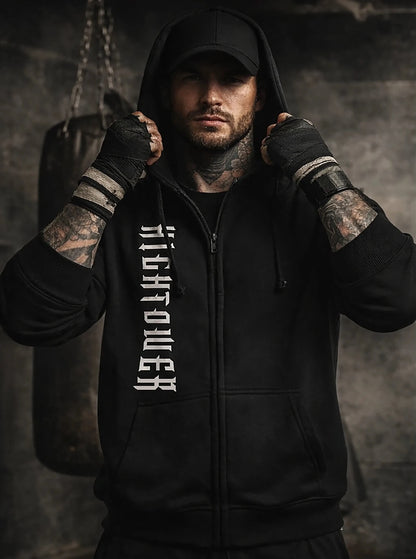 Man wearing a black hoodie with 'Righteous' text, standing against a dark background.