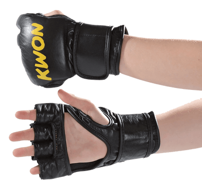 A pair of black leather Kwon-style MMA sparring gloves shown on hands against a white background, with one glove closed and one open to display the finger openings and wrist strap.