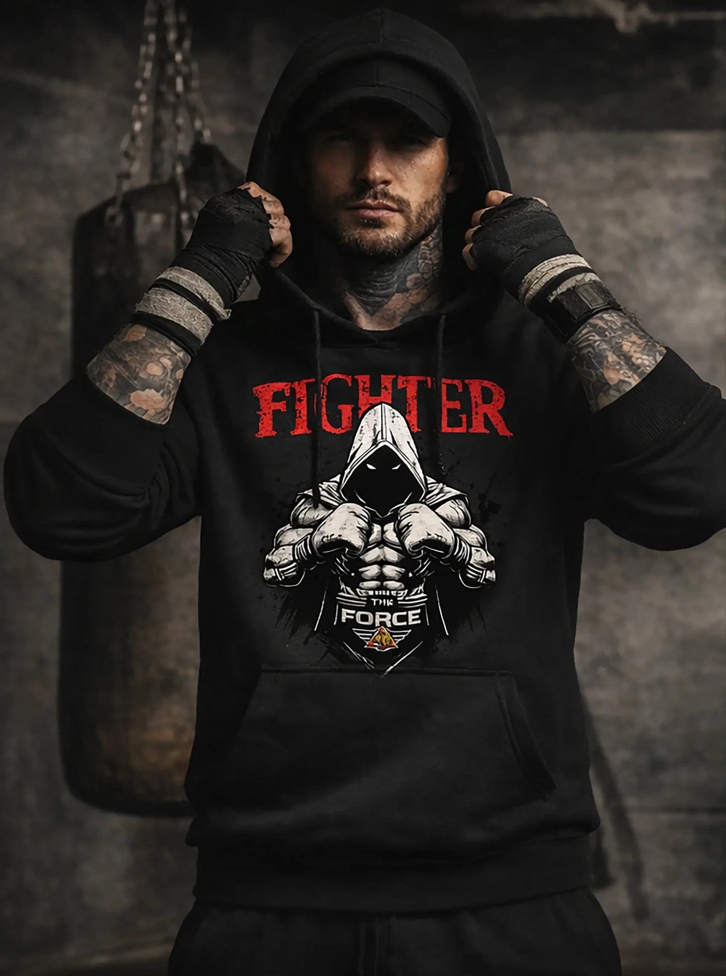 Person wearing a black hoodie with 'FIGHTER' text and graphic design, standing in a dark room.